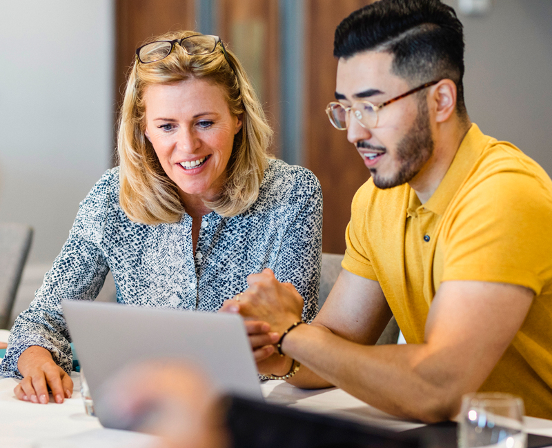 A manager reviewing an employee's MCode assessment results with them