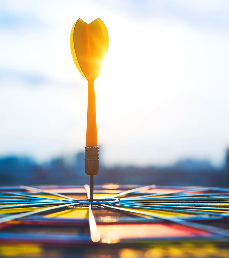 A yellow dart in the center of a colorful bullseye representing the accuracy of the Motivation Code assessment